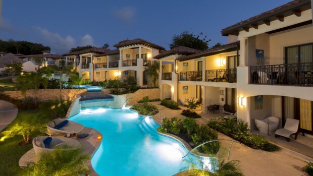 Luxury resort with pool and tropical plants in Grenada at dusk