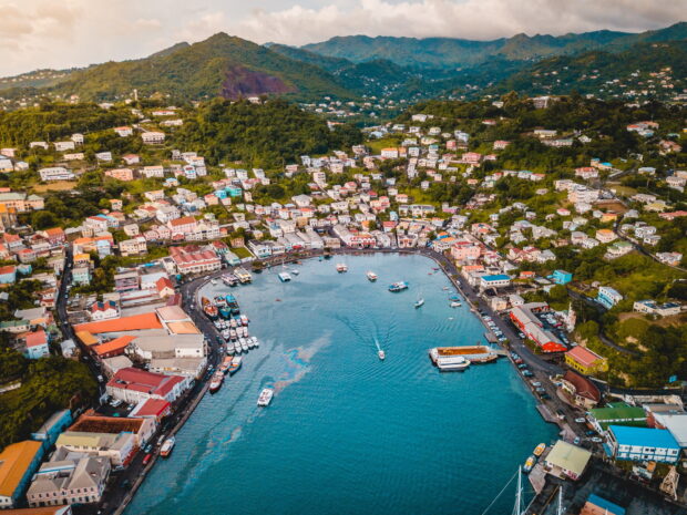 Aerial view of Grenada city and harbor with colorful buildings and lush green hills