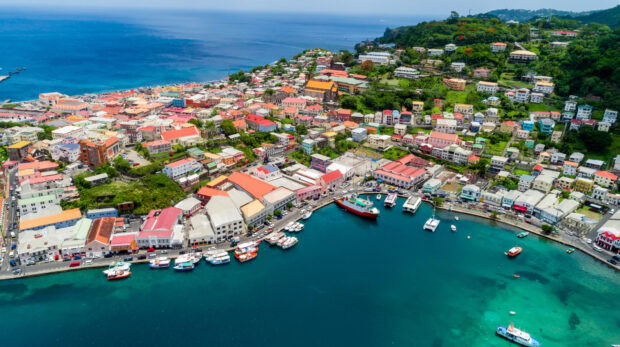 Aerial view of Grenada city with colorful buildings and clear turquoise water