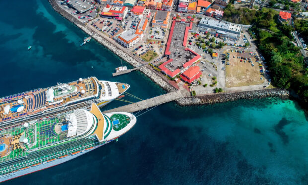 Aerial view of Grenada featuring a large cruise ship docked at the port and colorful buildings