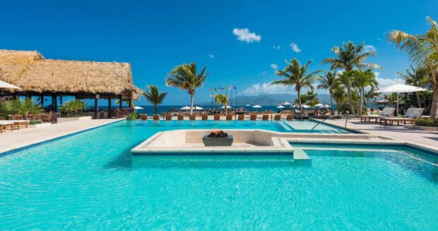 Tropical resort with palm trees and a large pool in Grenada