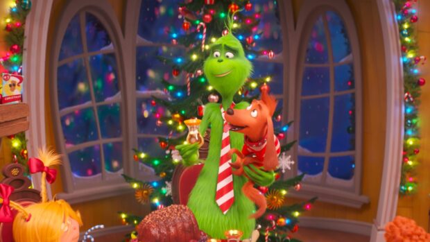 The Grinch holding a dog in front of a decorated Christmas tree in a festive room