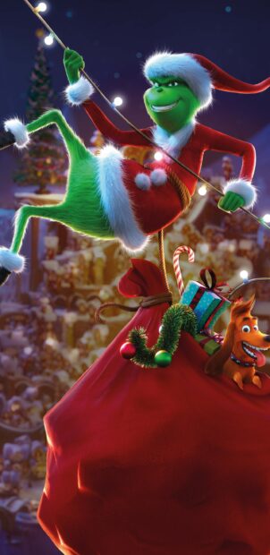 The Grinch in a Santa suit hanging on Christmas lights with a large red sack and a dog