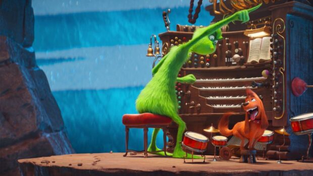 The grinch playing the organ with max the dog on a cliff edge