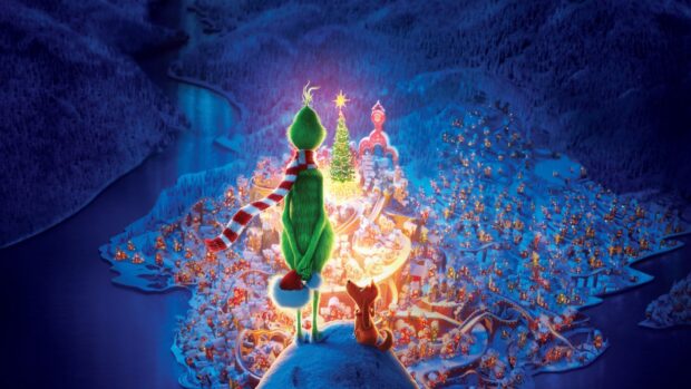 The Grinch standing on a snowy hill overlooking the bright Christmas town with his dog by his side