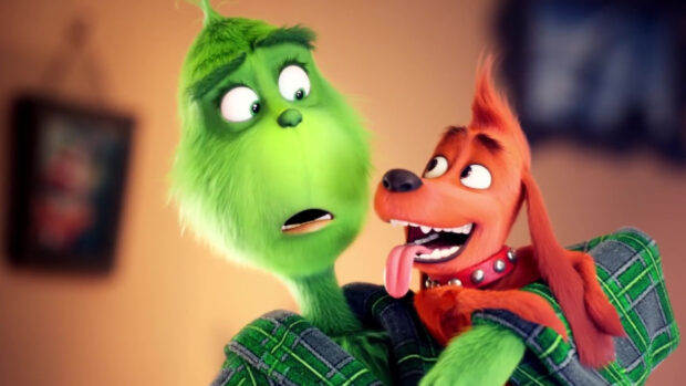 The Grinch holding his happy dog with tongue out in a cozy room