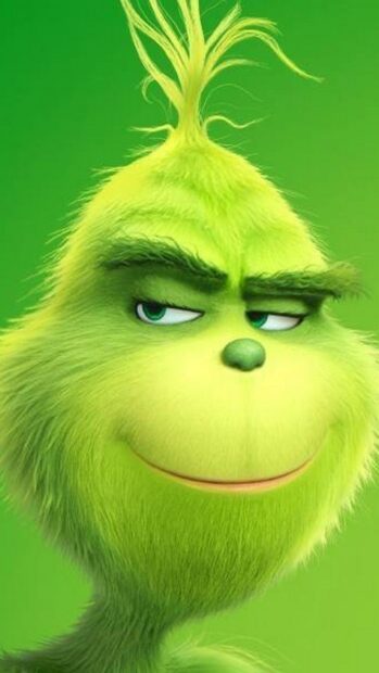 The Grinch character with a sly smile looking to the side in green fur