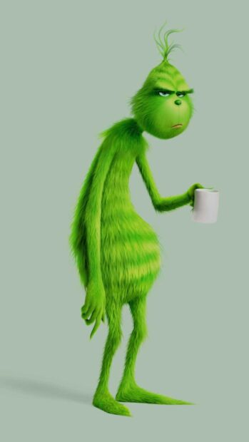 The Grinch holding a cup with a grumpy expression on a simple background