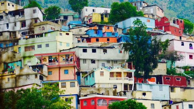 Colorful Haitian houses stacked on hillside in Haiti cityscape