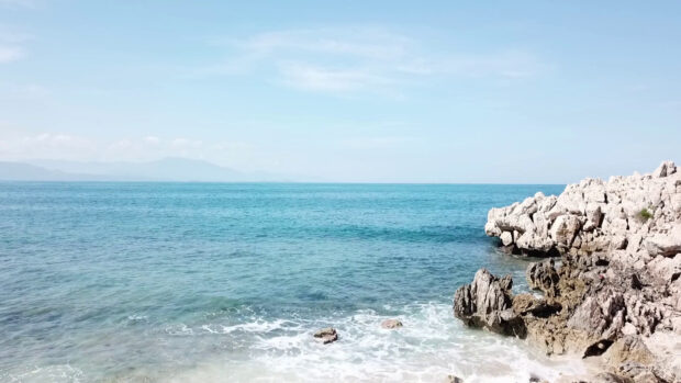 Rocky coastline with clear blue sea and sky in Haiti