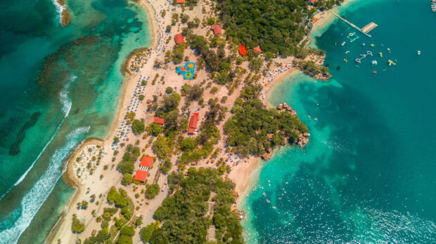 Aerial view of Haiti scenic coastline with turquoise water and sandy beaches surrounded by greenery