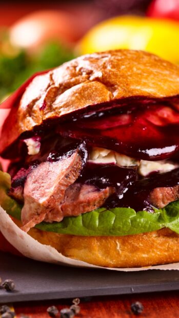 Close up of fresh lettuce and meat in a gourmet hamburger