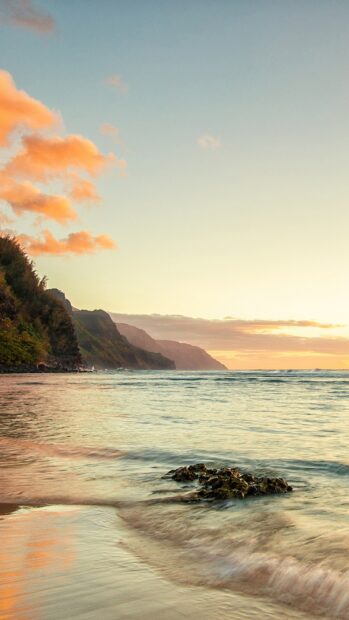 Hawaiian ocean with rocky shore and sunset sky on the Hawaiian coastline