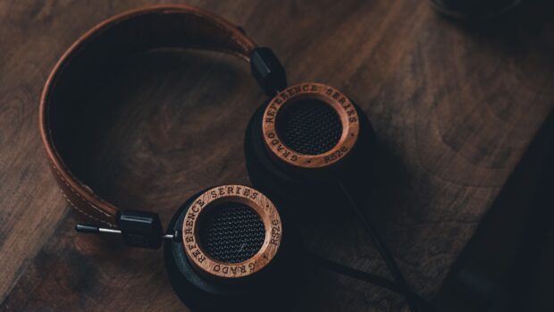 Vintage headphones with wooden reference series details on a wooden surface