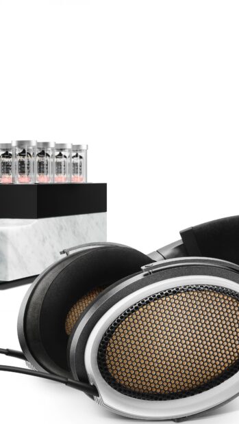 High quality headphones with mesh design and vacuum tubes on a white surface