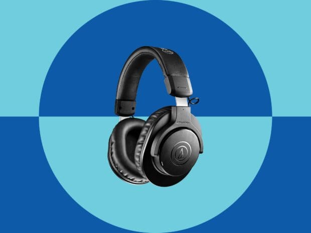 Black headphones with cushioned ear pads on a blue circular background