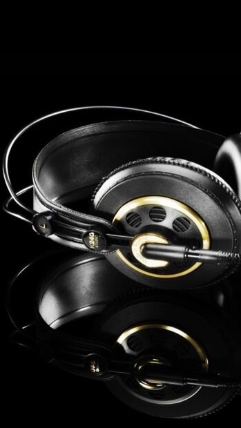 Black headphones with gold accents reflecting on glossy surface featuring K240 studio design