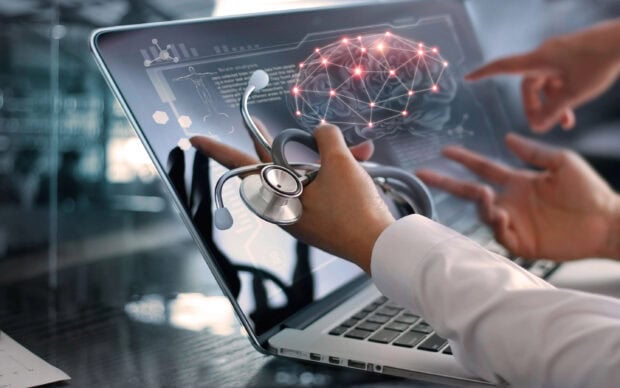 Medical technology showing brain analysis with stethoscope on laptop screen
