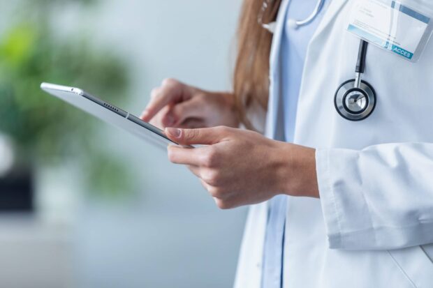 Medical professional holding a digital tablet using health technology