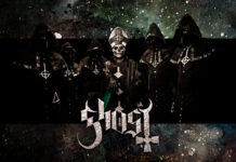 The heavy metal band Ghost members dressed in dark robes with a skull faced lead singer