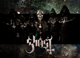 The heavy metal band Ghost members dressed in dark robes with a skull faced lead singer
