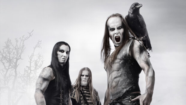 Three heavy metal musicians with face paint and a black raven on the shoulder of one band member