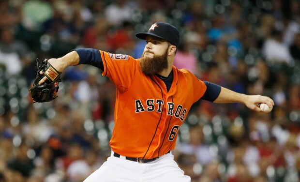 Houston Astros player pitching during a baseball game in orange jersey