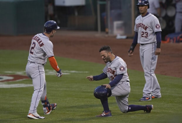 Houston Astros players celebrating during a baseball game on the field