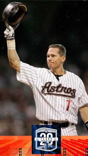 A Houston Astros player raising his helmet during a game in a striped jersey with number 7