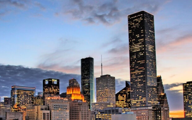 Houston city skyline with illuminated buildings during sunset in Texas