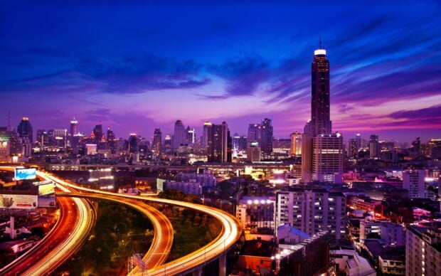 Evening cityscape with illuminated highways in Houston Texas skyline at dusk