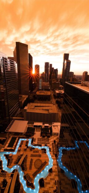 Sunset over Houston Texas cityscape with illuminated pool and skyscrapers in view