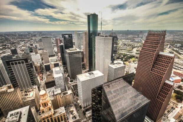 Modern cityscape of Houston Texas with tall skyscrapers and urban buildings under cloudy sky