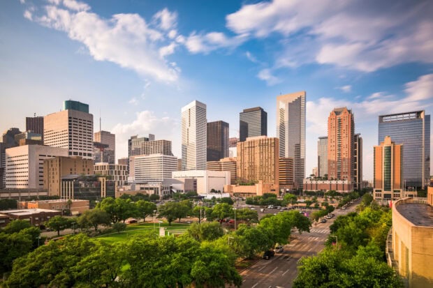 Downtown Houston Texas cityscape with tall buildings under a blue sky
