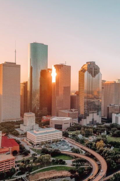 Cityscape of Houston Texas skyline during sunset with sunlight reflecting on buildings