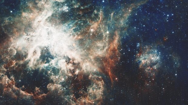 A vast colorful nebula captured by Hubble showing stars and cosmic dust in space