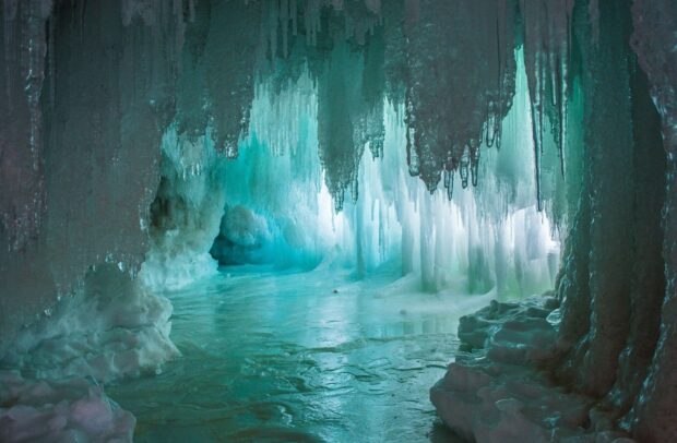 Stunning ice formations inside a frozen cave creating a magical winter scene