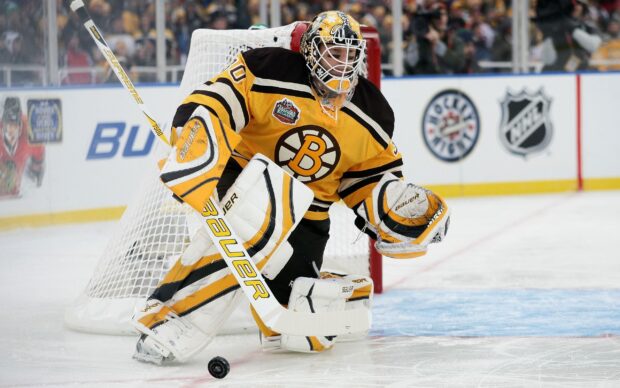 Ice hockey goalie in yellow uniform defending the net during a match