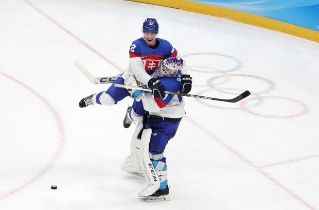 Ice hockey players celebrating a goal on the ice rink during a game