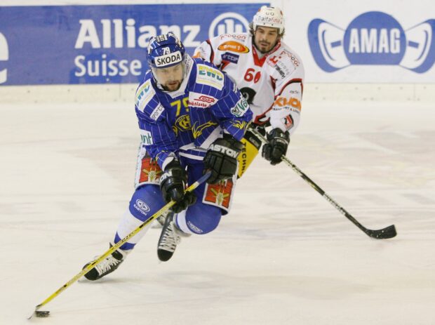 Ice hockey players competing for the puck during an intense ice hockey match