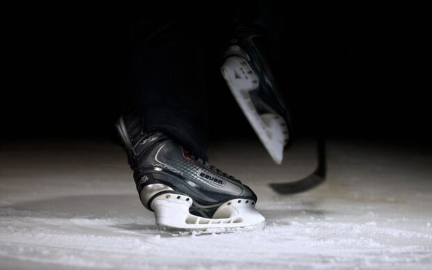 Close up of ice hockey skate gliding on ice surface