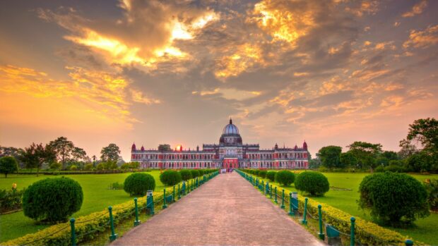 Beautiful India sunset view with historical architecture and lush green garden pathway