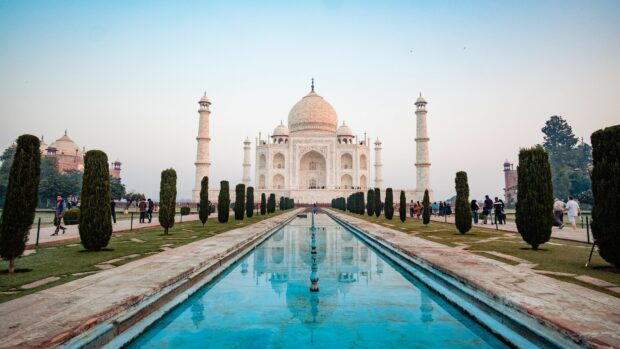 The Taj Mahal in India with its reflecting pool and surrounding garden in a clear sky