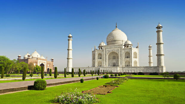 The Taj Mahal is a famous India monument with beautiful gardens and clear blue sky