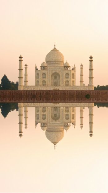 The Taj Mahal reflecting on water at sunrise showcasing iconic India architecture