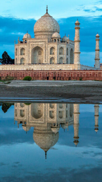 The Taj Mahal reflecting in water is a famous historical monument in India