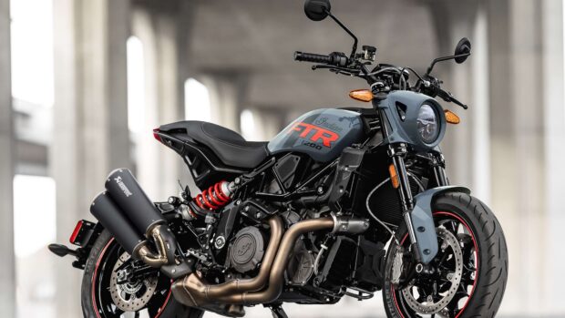 Close up of Indian bike with FTR logo and detailed engine parts in an urban setting