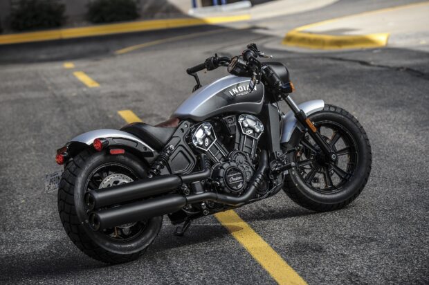 A silver Indian Scout bike parked on a street with clear road markings