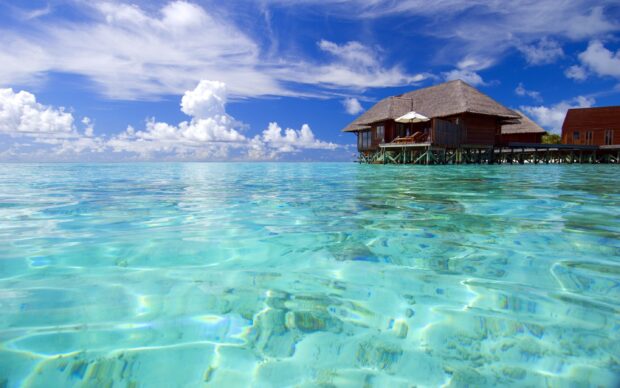 Clear turquoise water and overwater bungalows in Indian Ocean