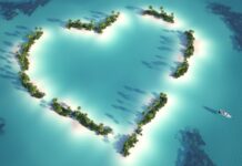 Heart shaped island greenery surrounded by turquoise waters in Indian Ocean